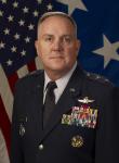 Photo of Major General Walsh in front of an American flag