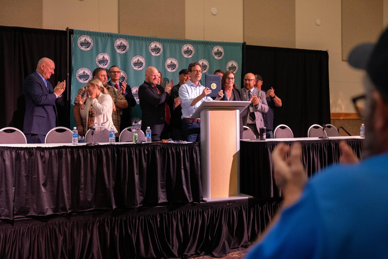 Governor Ferguson holds up Executive Order 25-07 on Project Labor Agreements