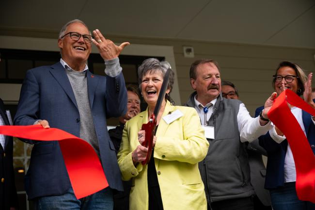Inslee pretends to have lost a finger after a (safe) ribbon cutting.